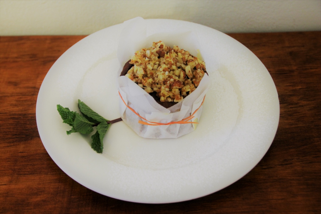 Delicious muffin with nut crumble topping and fresh mint